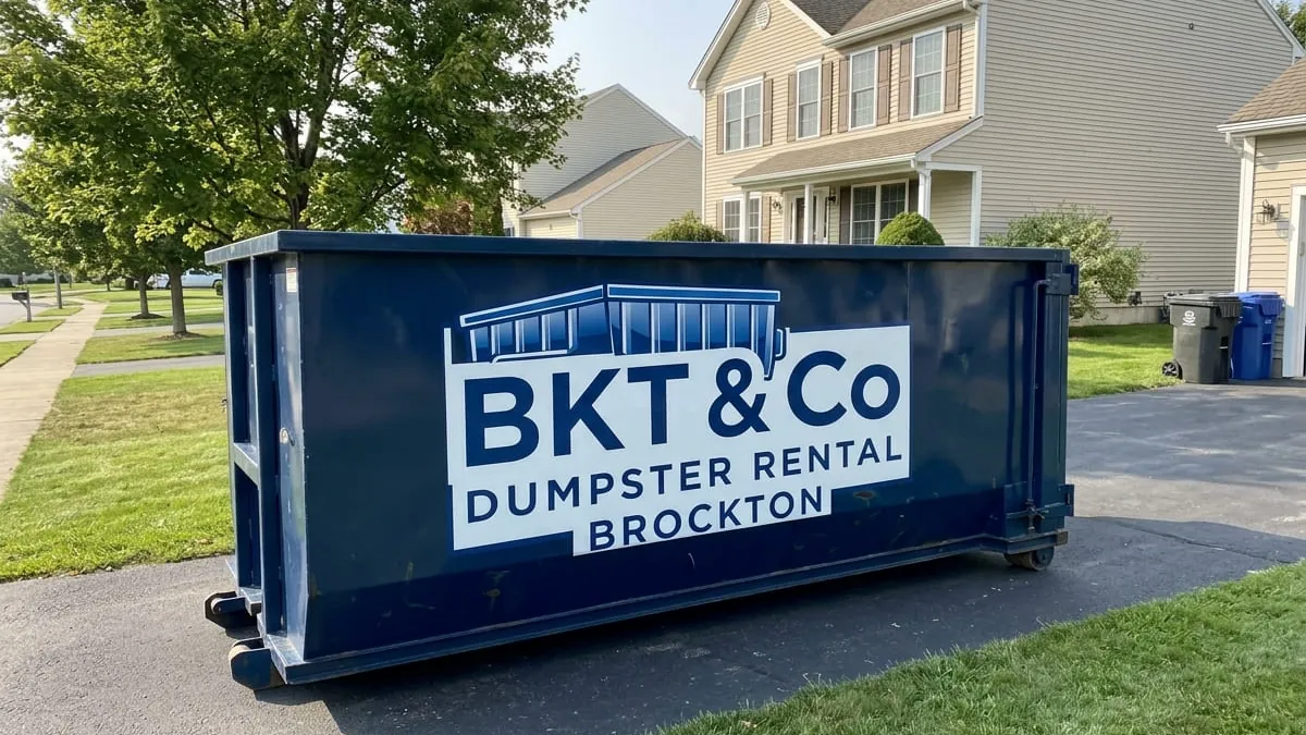 BKT & Co Dumpster Rental crew standing with a roll-off truck and 30 yard dumpster in a Brockton, MA driveway BKT & Co Dumpster Rental crew standing with a roll-off truck and 30 yard dumpster in a Brockton, MA driveway